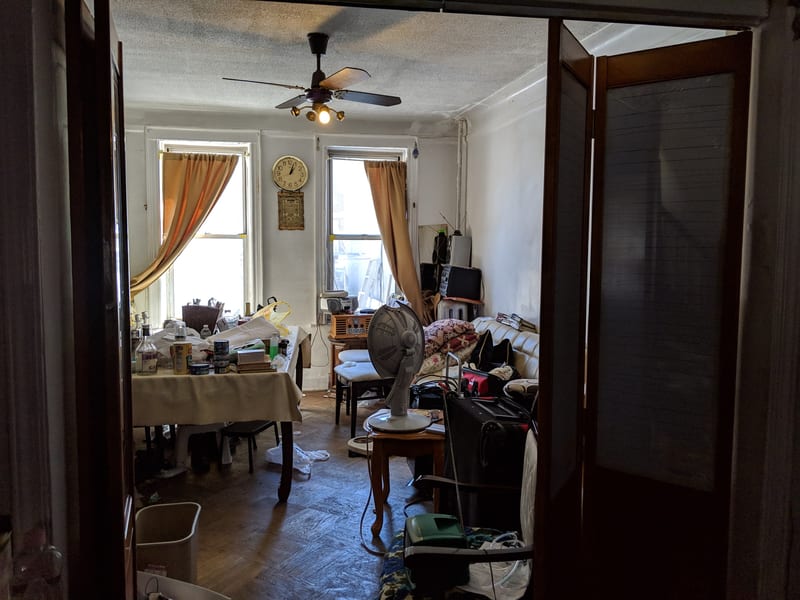 Kitchen before renovation — outdated cabinets and worn finishes